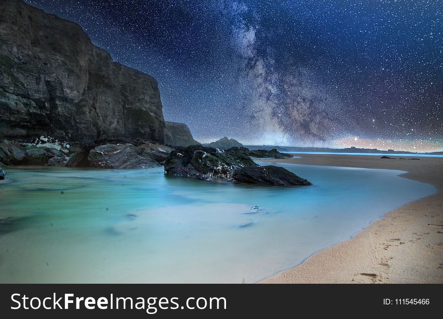 Black Stone on Body of Water during Nighttime