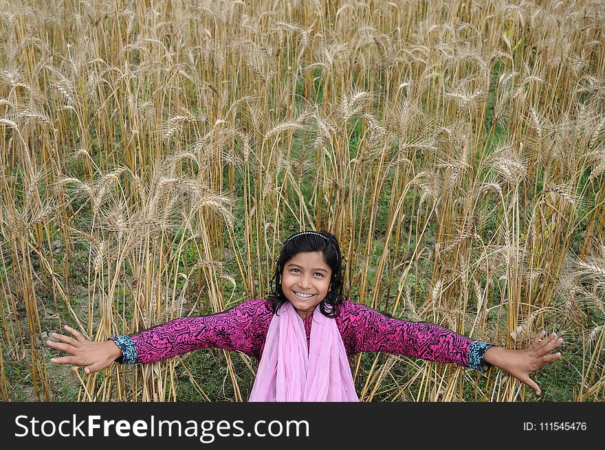Woman Taking Selfie in Brown Grass Field