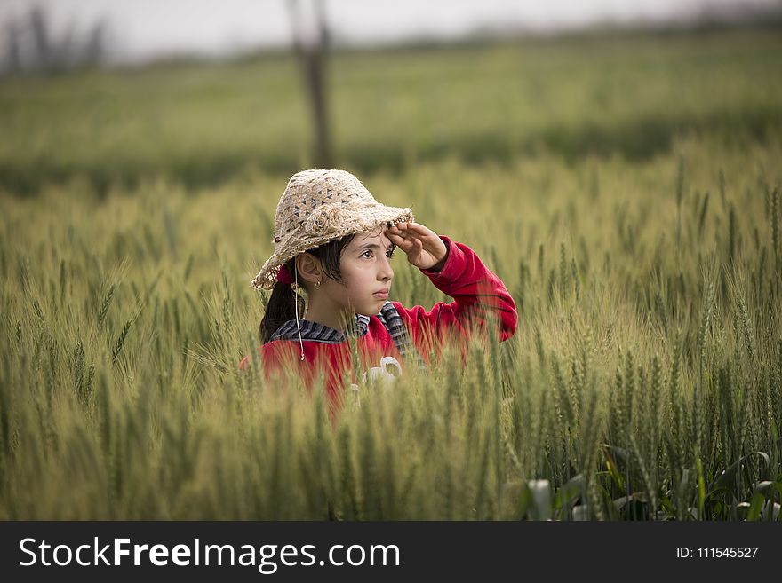 Girl In Red Hoodie Wearing Beige Sunhat