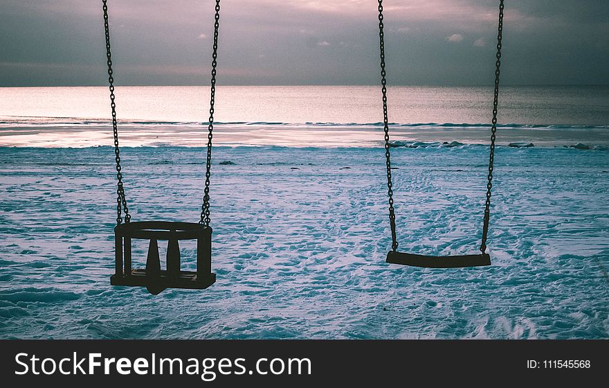 Silhouette Photo of Two Swings