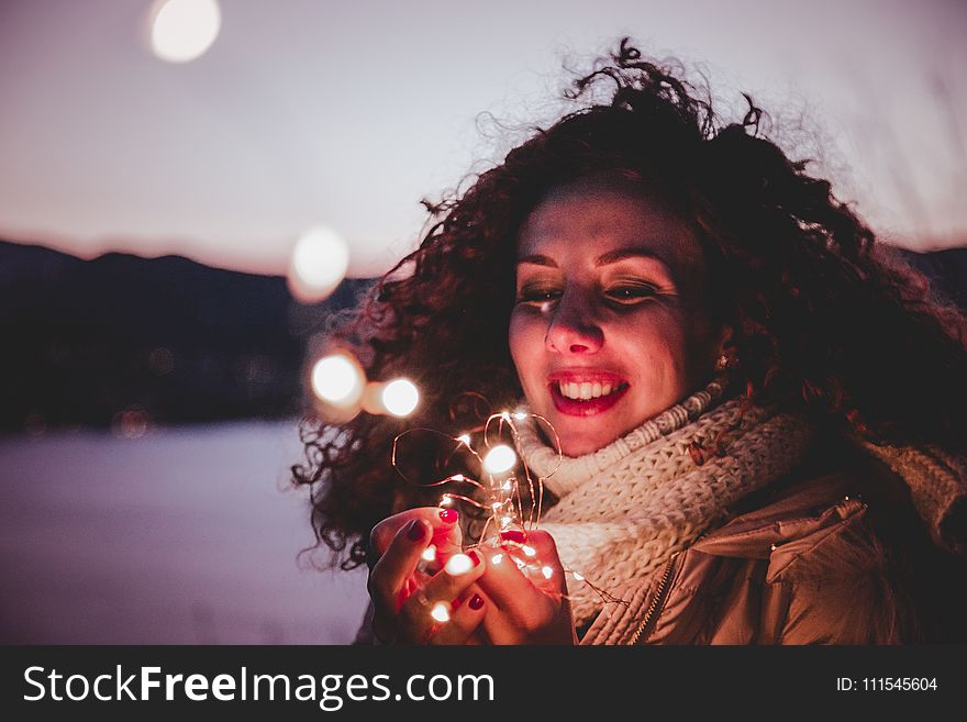 Woman Holding White String Lights