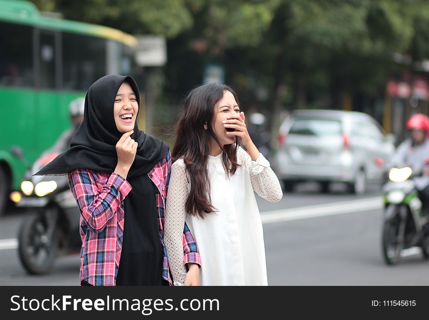 Two Women Laughing at Street