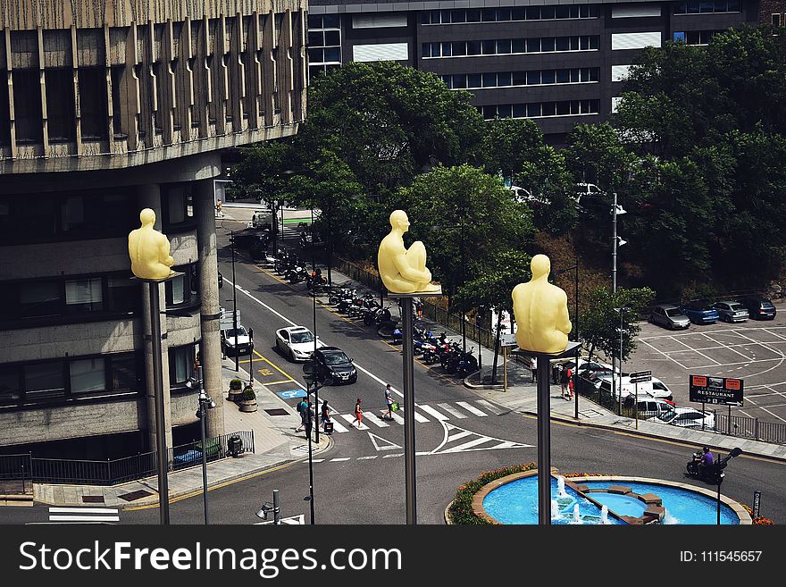Birds Eye View Photo of Sitting Statues on Outdoor Post
