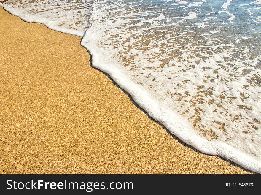 Brown Sand And Body Of Water