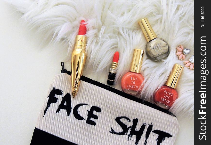 Photo Of Two Red Lipsticks And Three Assorted-color Nail Polish Bottles