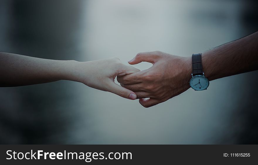 Photo of Two Persons Holding Hands