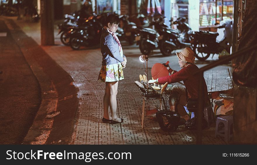 Woman buying from a street vendor