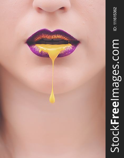 Women&#x27;s Purple and Yellow Lips With Yellow Liquid