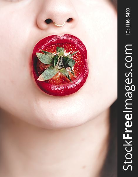 Woman With Strawberry on Mouth