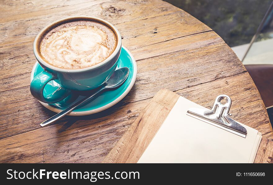 Cup of coffee with latte top view on wooden table