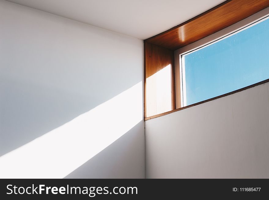 Clear Glass Window With Brown and White Wooden Frame