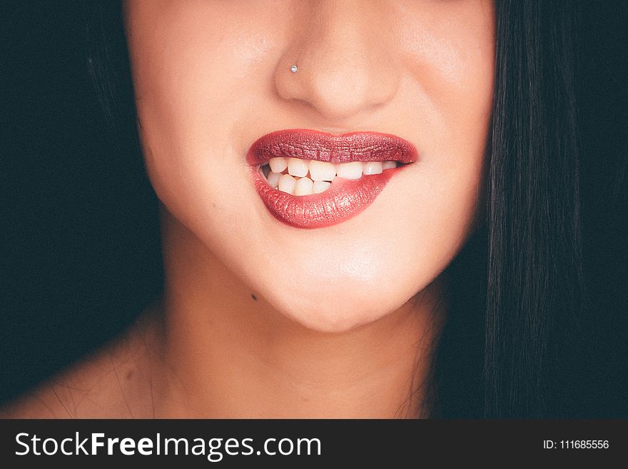Woman Biting Red Lips With Nose Pin