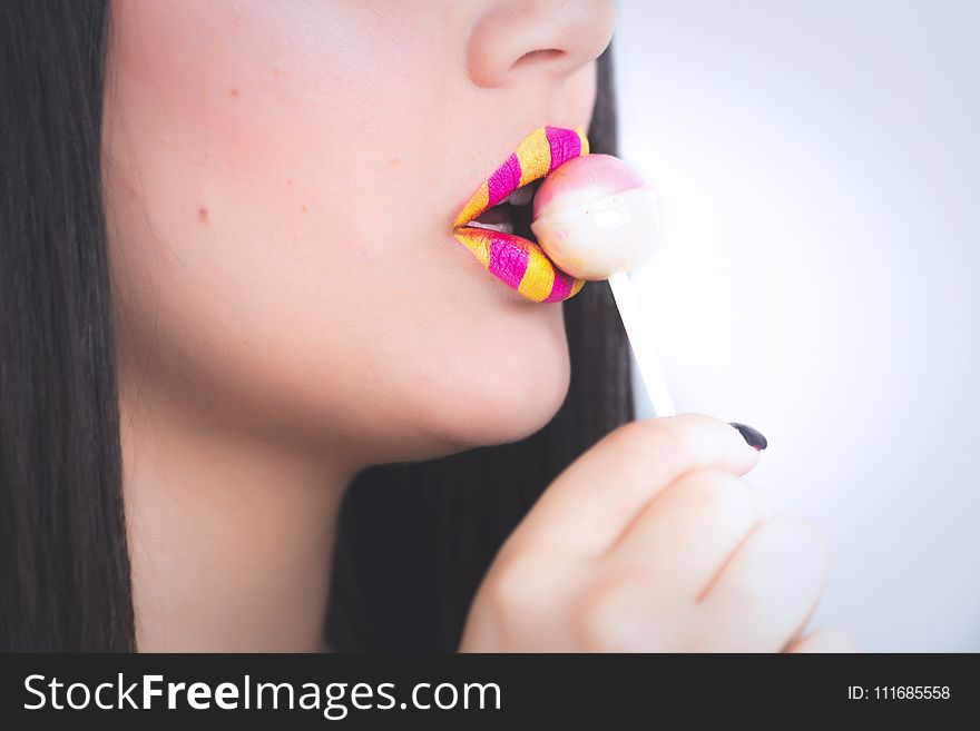 Woman Holding a Lollipop