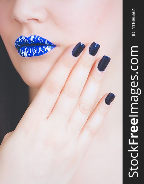 Woman Wearing Blue And White Lipstick With Black Manicure