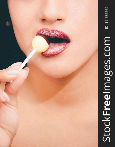 Woman With Red Lipstick Licking A Lollipop