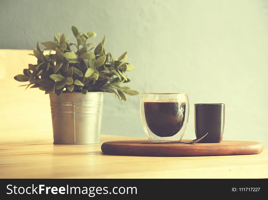 Coffee cup on a wooden table and sack background,Vintage color tone