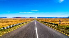 Long Straight Road Through The Endless Wide Open Landscape Of The Semi Desert Karoo Region In Free State And Eastern Cape Province Royalty Free Stock Photography