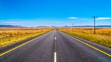 Long Straight Road Through The Endless Wide Open Landscape Of The Semi Desert Karoo Region In Free State And Eastern Cape Province Stock Images