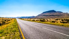Long Straight Road Through The Endless Wide Open Landscape Of The Semi Desert Karoo Region In Free State And Eastern Cape Province Royalty Free Stock Image Long Straight Road Through The Endless Wide Open Landscape Of The Semi Desert Karoo Region In Free State And Eastern Cape Province Royalty Free Stock Image