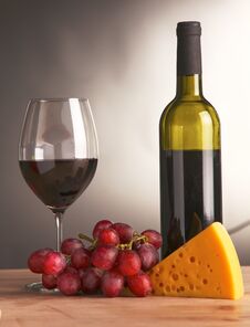 Still Life With Glass And Bottle Of Wine, Cheese And Grapes Stock Images