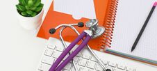 Doctor`s Workspace Working Table With Patient`s Discharge Blank Paper Form, Medical Prescription, Stethoscope On Desk Stock Photography