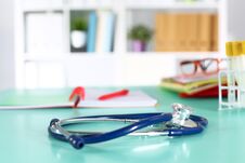 Doctor`s Workspace Working Table With Patient`s Discharge Blank Paper Form, Medical Prescription, Stethoscope On Desk Stock Photo