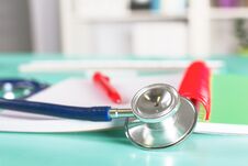 Doctor`s Workspace Working Table With Patient`s Discharge Blank Paper Form, Medical Prescription, Stethoscope On Desk Royalty Free Stock Photos