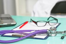 Doctor`s Workspace Working Table With Patient`s Discharge Blank Paper Form, Medical Prescription, Stethoscope On Desk Royalty Free Stock Photos