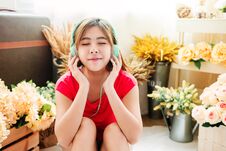 Happy Young Woman Listening Music From Smart Phone In Cozy House Royalty Free Stock Image