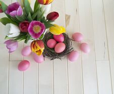 Easter. Pink Easter Eggs And Tulips Lie On A Wooden Background. Flat Lay. Royalty Free Stock Image