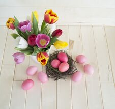 Easter. Pink Easter Eggs And Tulips Lie On A Wooden Background. Flat Lay. Royalty Free Stock Photos