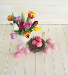 Easter. Pink Easter Eggs And Tulips Lie On A Wooden Background. Flat Lay. Stock Image