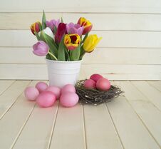Easter. Pink Easter Eggs And Tulips Lie On A Wooden Background. Flat Lay. Royalty Free Stock Photo Easter. Pink Easter Eggs And Tulips Lie On A Wooden Background. Flat Lay. Royalty Free Stock Photo