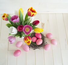 Easter. Pink Easter Eggs And Tulips Lie On A Wooden Background. Flat Lay. Royalty Free Stock Photography
