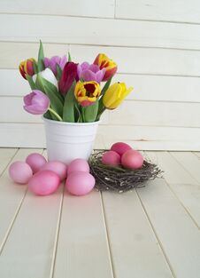 Easter. Pink Easter Eggs And Tulips Lie On A Wooden Background. Flat Lay. Stock Image Easter. Pink Easter Eggs And Tulips Lie On A Wooden Background. Flat Lay. Stock Image