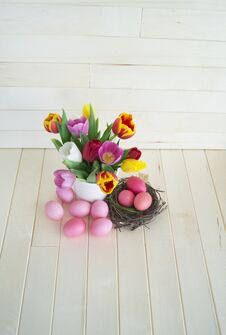 Easter. Pink Easter Eggs And Tulips Lie On A Wooden Background. Flat Lay. Stock Photography Easter. Pink Easter Eggs And Tulips Lie On A Wooden Background. Flat Lay. Stock Photography