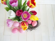 Easter. Pink Easter Eggs And Tulips Lie On A Wooden Background. Flat Lay. Stock Images