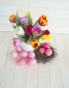 Easter. Pink Easter Eggs And Tulips Lie On A Wooden Background. Flat Lay. Royalty Free Stock Images