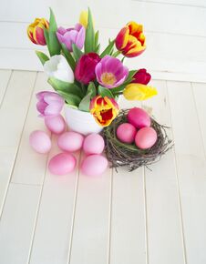 Easter. Pink Easter Eggs And Tulips Lie On A Wooden Background. Flat Lay. Stock Images