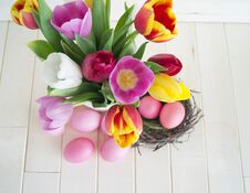 Easter. Pink Easter Eggs And Tulips Lie On A Wooden Background. Flat Lay. Royalty Free Stock Images Easter. Pink Easter Eggs And Tulips Lie On A Wooden Background. Flat Lay. Royalty Free Stock Images