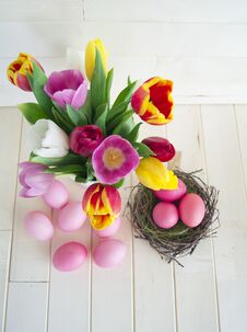Easter. Pink Easter Eggs And Tulips Lie On A Wooden Background. Flat Lay. Royalty Free Stock Photography Easter. Pink Easter Eggs And Tulips Lie On A Wooden Background. Flat Lay. Royalty Free Stock Photography