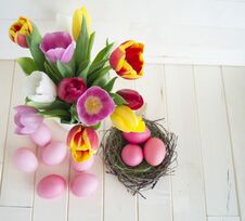 Easter. Pink Easter Eggs And Tulips Lie On A Wooden Background. Flat Lay. Royalty Free Stock Images