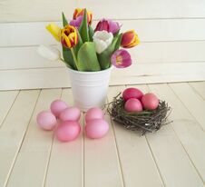 Easter. Pink Easter Eggs And Tulips Lie On A Wooden Background. Flat Lay. Stock Photos