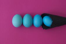 Easter. Blue Eggs Are Poured From A Waffle Cone From Ice Cream. Black Waffle Cone. Royalty Free Stock Photography