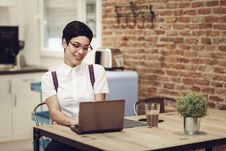 Spain, Madrid, Madrid. Young Woman With Very Short Haircut Typing With A Laptop At Home. Working At Home Concept. Royalty Free Stock Photography Spain, Madrid, Madrid. Young Woman With Very Short Haircut Typing With A Laptop At Home. Working At Home Concept. Royalty Free Stock Photography