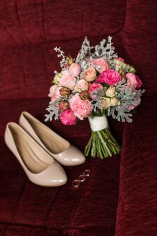 Wedding Bouquet With Purple And Pink Roses. Wedding Accessories Are Lying On A Red Armchair Stock Photography