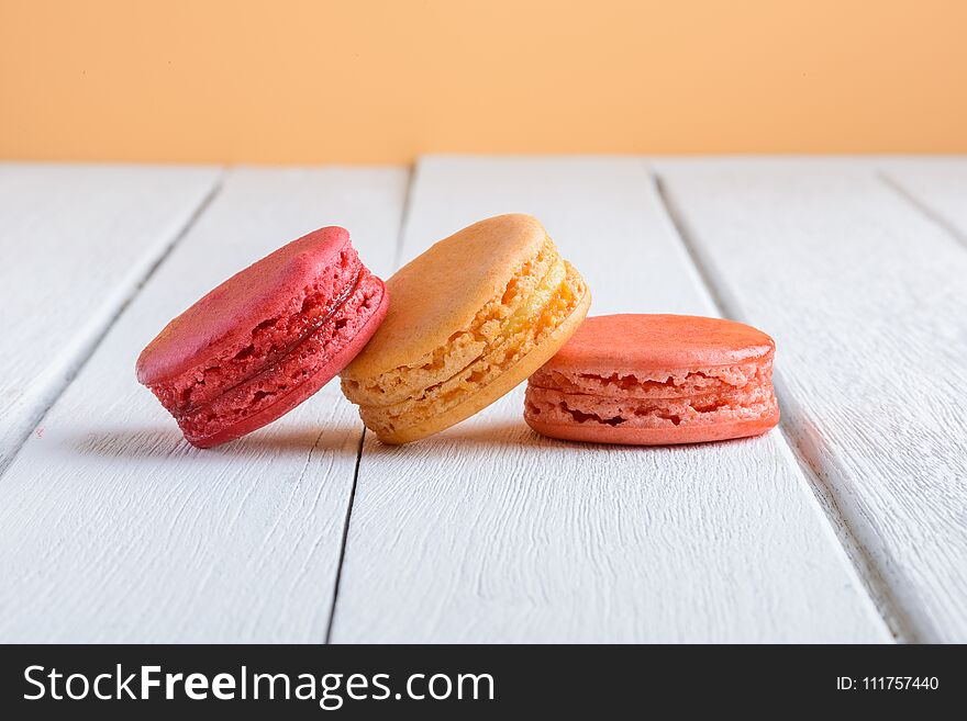 Different Types Color Of Macaroons On White Wooden Background