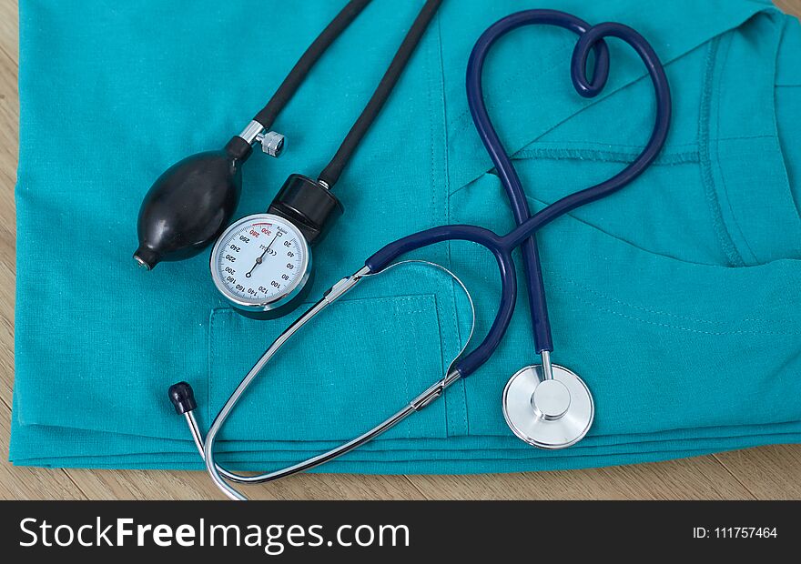 Medical devices stethoscope, tonometer on medical uniform.