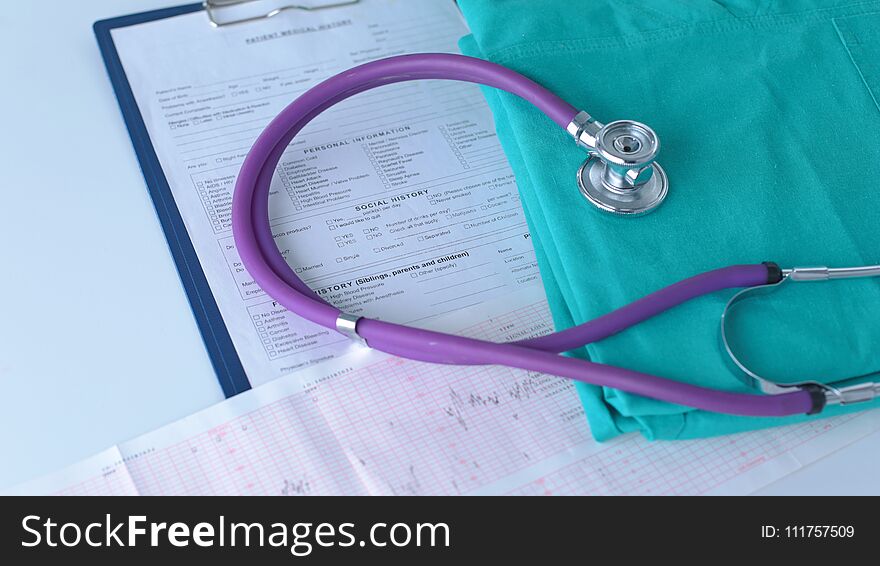 A stethoscope shaping a heart on a medical uniform, closeup