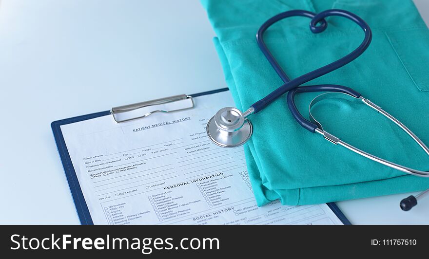 A stethoscope shaping a heart on a medical uniform, closeup